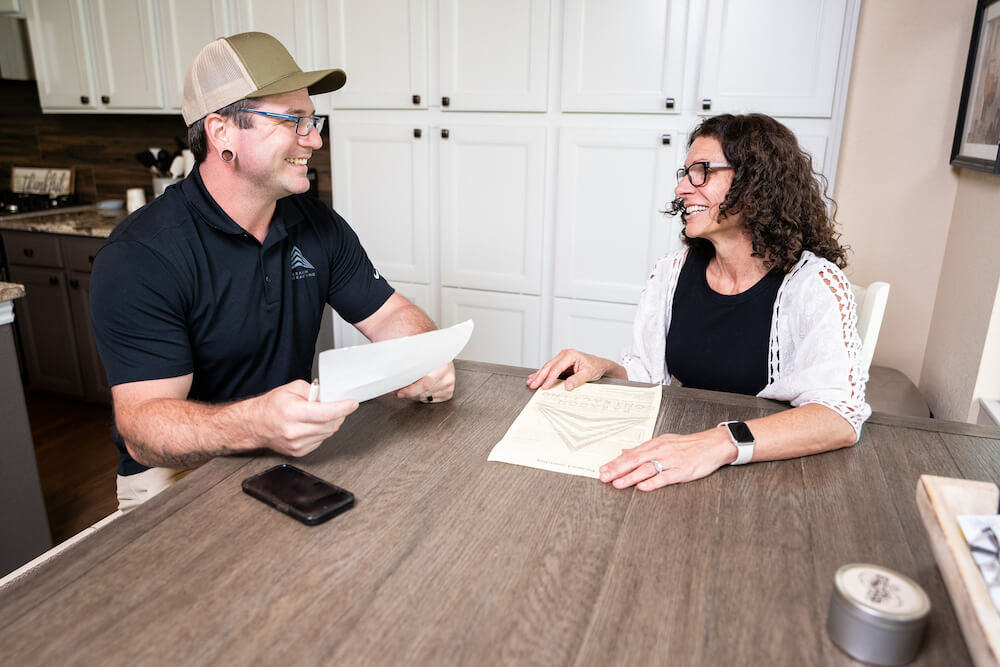 homeowner signing roofing contractor