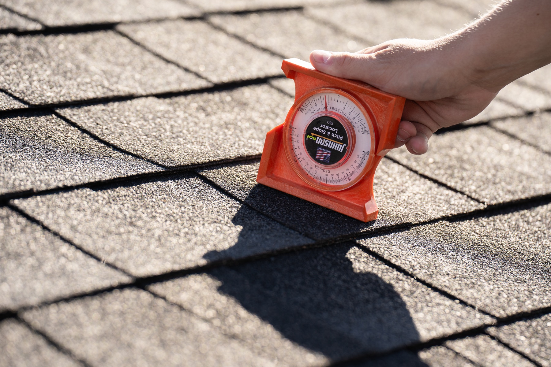 Paragon contractor checking a roof pitch
